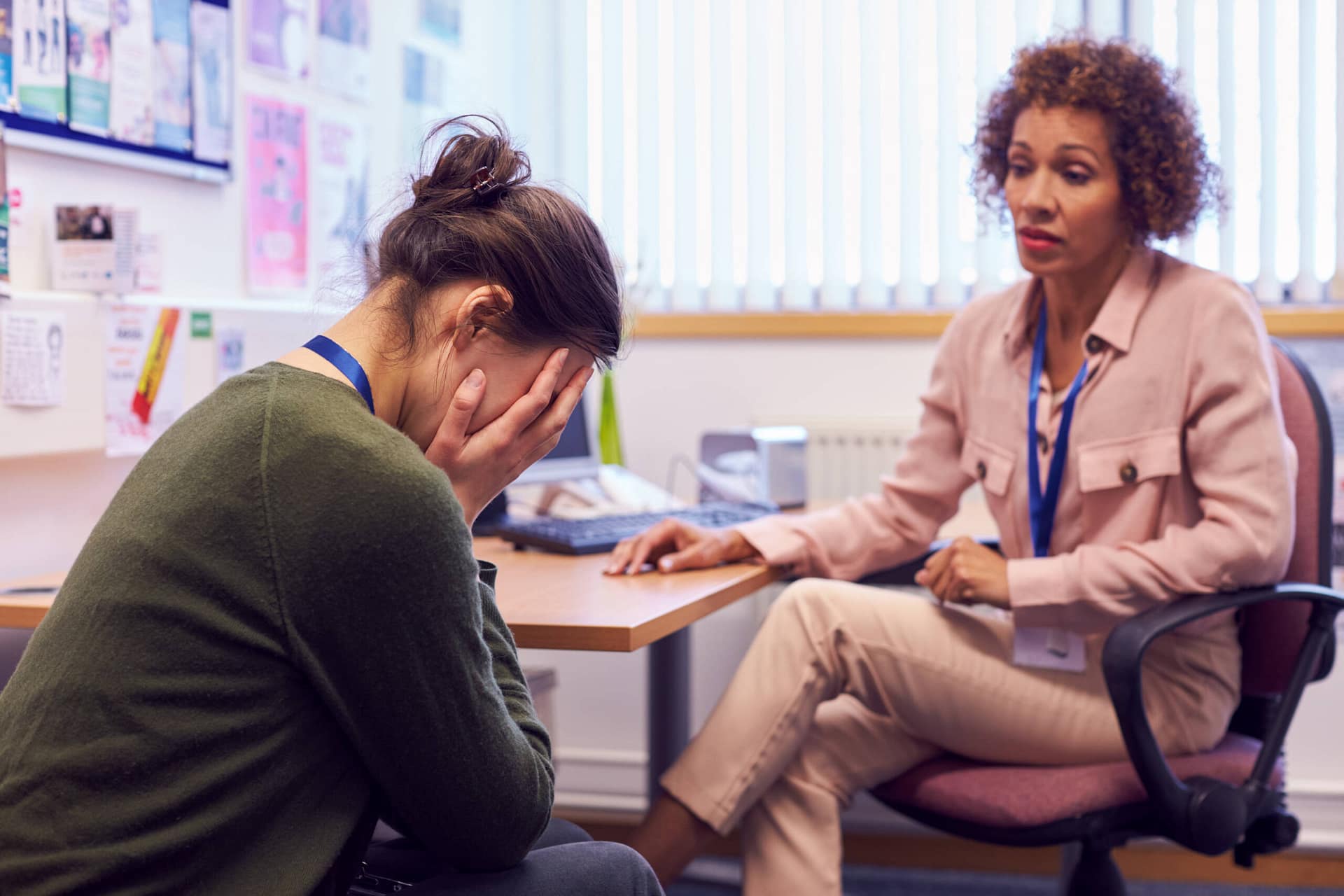 Female College Student Meeting With Campus Counselor Discussing Mental Health Issues Female College Student Meeting With Campus Counselor Discussing Mental Health Issues