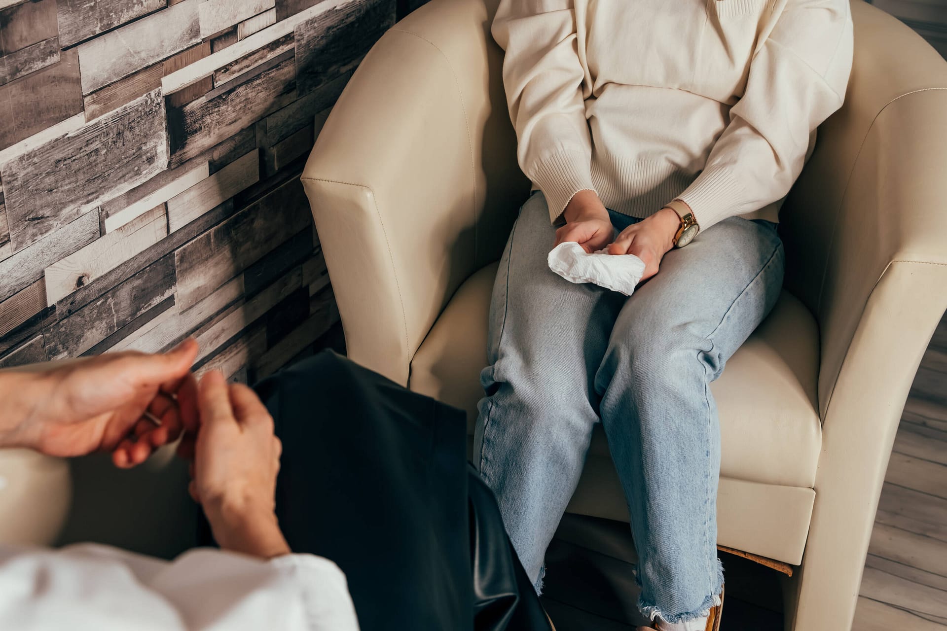 Psychologist counseling patient. Doctor in consultation with patient Psychologist counseling patient. Hands of man attending private psychologal therapy, doctor making notes while patient sharing his thoughts. Young female doctor in consultation with patient